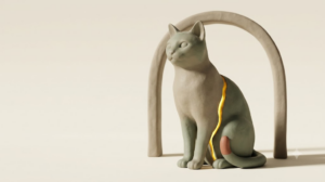 A sculpted matte clay cat sitting upright, marked by one bright golden light element.