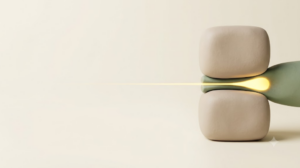 Sage clay cord squeezed between two blocks with golden light pooling before the pinch